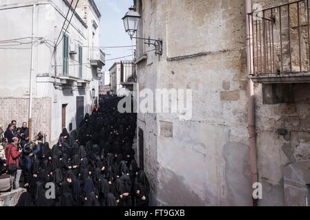 Canosa Di Puglia, Italy. 26th Mar, 2016. On the Holy Saturday, during the week of Easter, takes place in Canosa di Puglia (Province of Barletta-Andria-Trani), the procession of the Desolata (Our Lady of Sorrows). The statue of the Virgin is followed by a group of about three hundred and fifty girls, totally dressed in black and with their face covered by a black veil, who sing the heartbreaking song by the name of 'Hymn of the Desolate'. Credit:  Michele Amoruso/Pacific Press/Alamy Live News Stock Photo
