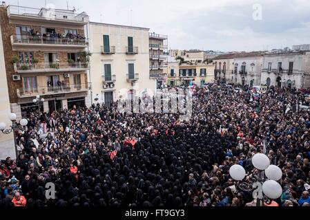 Canosa Di Puglia, Italy. 26th Mar, 2016. On the Holy Saturday, during the week of Easter, takes place in Canosa di Puglia (Province of Barletta-Andria-Trani), the procession of the Desolata (Our Lady of Sorrows). The statue of the Virgin is followed by a group of about three hundred and fifty girls, totally dressed in black and with their face covered by a black veil, who sing the heartbreaking song by the name of 'Hymn of the Desolate'. Credit:  Michele Amoruso/Pacific Press/Alamy Live News Stock Photo
