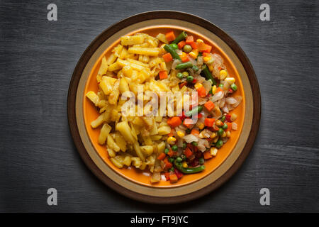 Fried potato with vegetables on plate Stock Photo