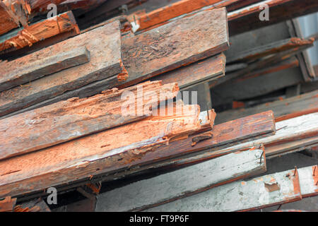 Pile of old used timber planks. Old, rotten, scrapped floorboards and decking planks amassed and scattered in heap. Stock Photo