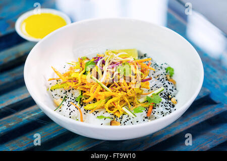 curry sauce vegetable salad with noodles and sesame modern asian fusion dish Stock Photo