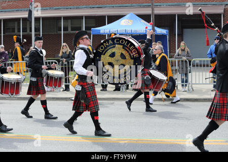 Iona College Pipes and Drums band marching in St. Patrick's Day parade Yonkers New York Stock Photo