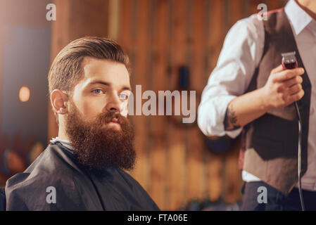 Bearded man sitting in the barbershop Stock Photo