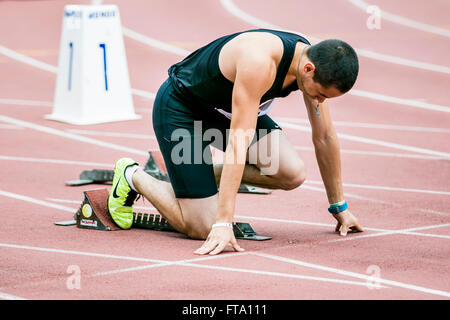 Chelyabinsk, Russia - July 05, 2015: Man athlete in starting position during Championship of Russia on track and field athletics Stock Photo