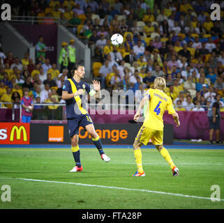 Zlatan Ibrahimovic of Sweden (L) fights for a ball with Anatoliy Tymoshchuk of Ukraine during their UEFA EURO 2012 game Stock Photo