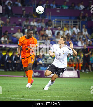 KHARKIV, UKRAINE - 13 June, 2012: Miroslav Klose of Germany (R) fights for a ball with Jetro Willems of Netherlands during their UEFA EURO 2012 game on Kharkiv Arena Stock Photo