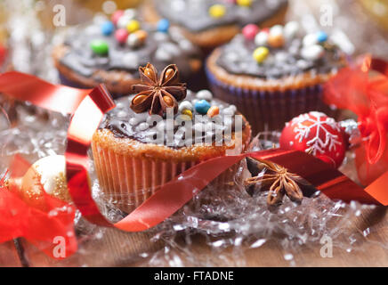 Decorated Christmas cupcakes with ribbon and candies Stock Photo