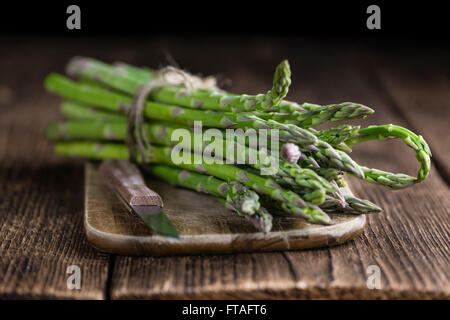 Fresh green Asparagus (selective focus, close-up shot) on wooden background Stock Photo