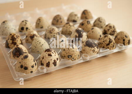 quail eggs on a wooden table in a plastic wrap Stock Photo
