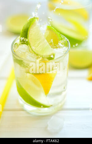 Cocktail lemon and lime in a glass with water splashes Stock Photo