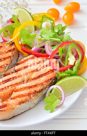 Plate Of Roasted Salmon Filet And Vegetables On Wooden Kitchen Table 