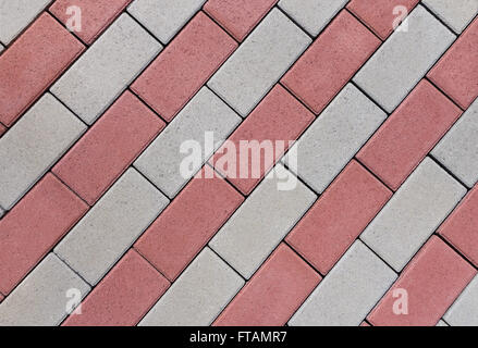 Diagonal pattern of rows of rectangular, red and gray cobblestones in close-up Stock Photo