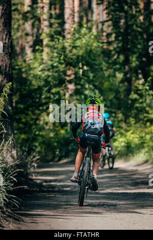Miass, Russia - July 19, 2015: Mountainbiker rides in forest during race "Clean water-2015" Stock Photo