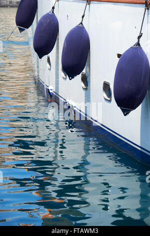 A Fender (boating) hanging on the board to protect the side of the sailing vessel from the damage. Malta. Stock Photo