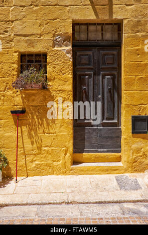 A door and a window of old house in the street of the old capital Vittoriosa, Malta Stock Photo