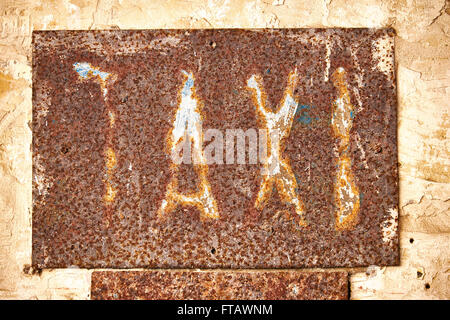 Old caption taxi on a rusty metal plate Stock Photo