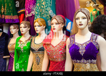 Shop mannequins in Indian Asian dresses and saris in retail shop display Stock Photo