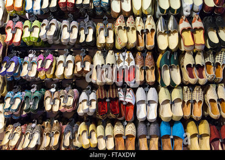 Indian and Oriental shoes and slippers on display in footwear shop Stock Photo