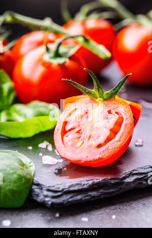 Tomatoes. Cherry tomatoes. Cocktail tomatoes. Fresh grape tomatoes carafe with olive oil on table. Toned photo Stock Photo