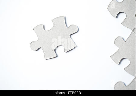 cardboard puzzles pieces on a white background Stock Photo