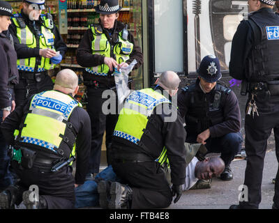 London, UK. 22nd Mar, 2016. A man is arrested outside Victoria station in London - LBC suggests he was wielding a gun on a bus © Stock Photo