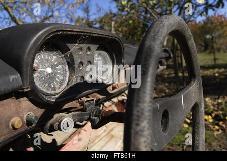 Rusty vintage car cut in half on a sunny day in autumn Stock Photo