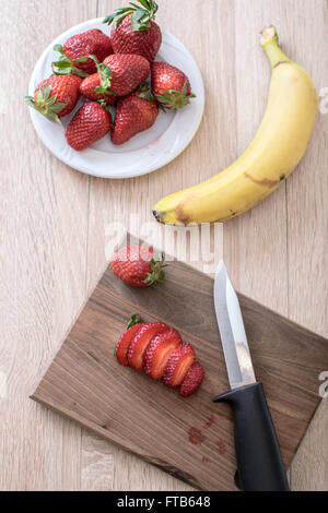 Fruit slices on a cutting board , from above Stock Photo