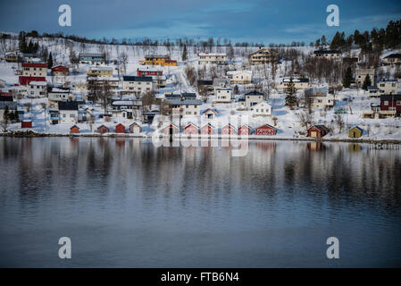 Red boat houses at the side of a fjord near Tromso, Norway. Stock Photo