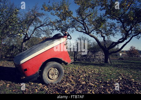 Rusty vintage car cut in half on a sunny day in autumn Stock Photo