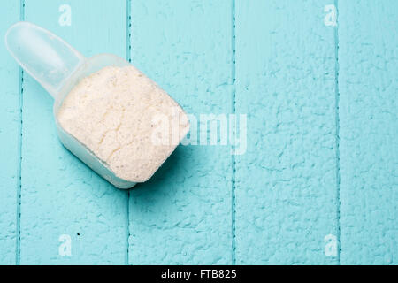 Plastic Measuring Scoop Of White Powder Whey Protein Against Grunge Wood  Background Stock Photo, Picture and Royalty Free Image. Image 13746751.