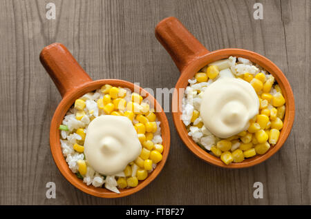 Salad with rice and canned corn on wooden background. Stock Photo