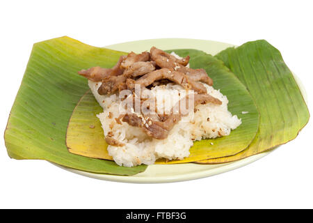 stick rice with pork wrapped in banana leaves. traditional and street food in thailand. Stock Photo
