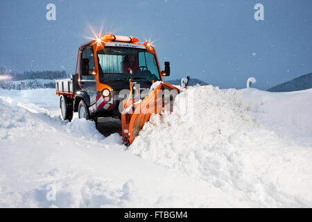 Snowplow removing snow, winter maintenance, Inn Valley, Kufstein district, Tyrol, Austria Stock Photo
