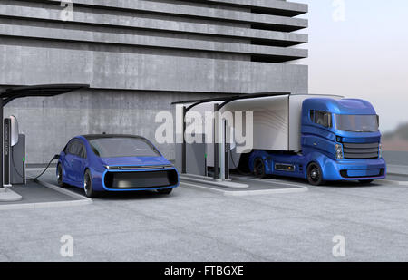 Hybrid electric truck and white electric car in charging station Stock Photo