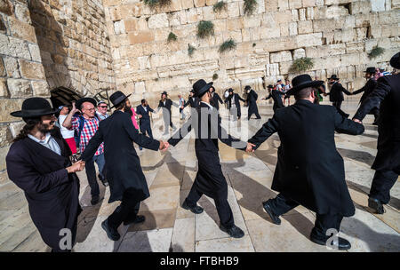 Orthodox Jews dancing in front of Western Wall (also called Kotel or Wailing Wall), Jewish Quarter, Old Town, Jerusalem, Israel Stock Photo