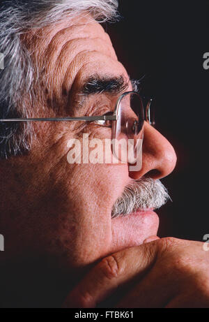 Studio portrait of distinquished older gentleman with eyeglasses, mustache & grey hair Stock Photo