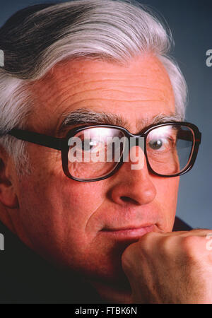 Studio portrait of distinquished gentleman with eyeglasses & silver grey hair Stock Photo