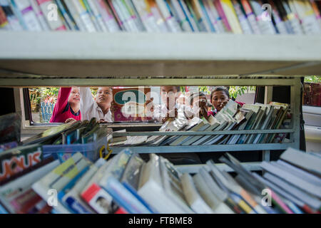 Students of primary school is very enthusiastic about choosing the books in the library car Stock Photo