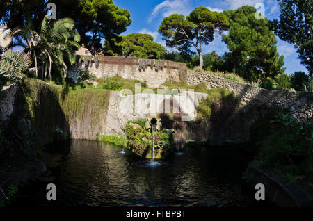 Fountain in a park with water flowing from an old amphora, Cagliari, Sardinia Stock Photo