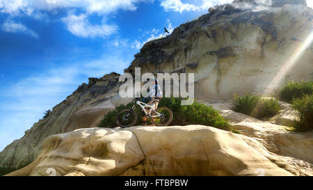 Mountain cyclist admires the views from the historic mountain of Tel Zafit (Gath of the Philistines). Stock Photo