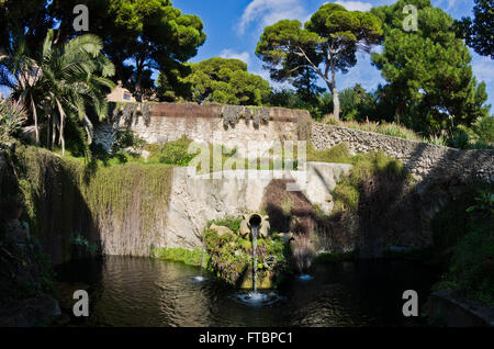 Fountain in a park with water flowing from an old amphora, Cagliari, Sardinia Stock Photo