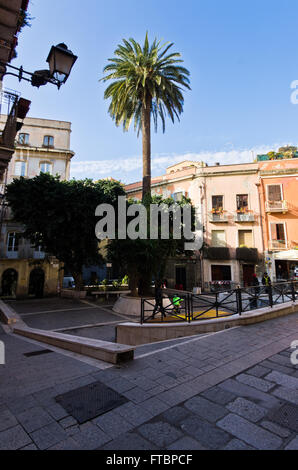 Small square with palm trees, streets of Cagliari downtown, Sardinia Stock Photo