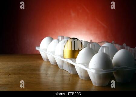 Golden egg among ordinary eggs. 3d image. Isolated white background Stock  Photo - Alamy