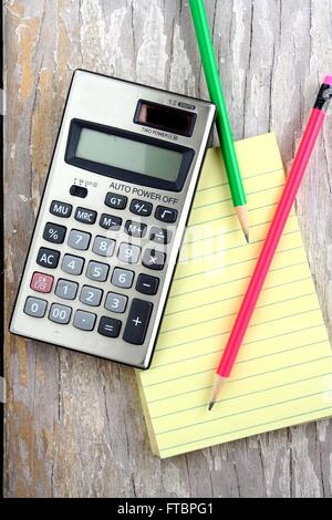 calculator, colored pencils and notepad Stock Photo