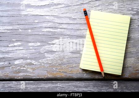 Pencil and a notepad on a table Stock Photo