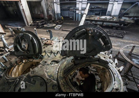 Workers repair tanks in a workshop at the Lviv Armor Plant Stock Photo