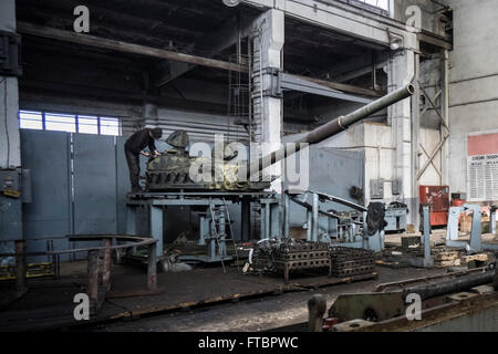 Workers repair tanks in a workshop at the Lviv Armor Plant Stock Photo