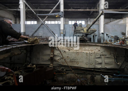 Workers repair tanks in a workshop at the Lviv Armor Plant Stock Photo