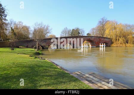 The old river Thames crossing at Sonning viewed from the east side showing the arches built in red brick and the flowing river. Stock Photo