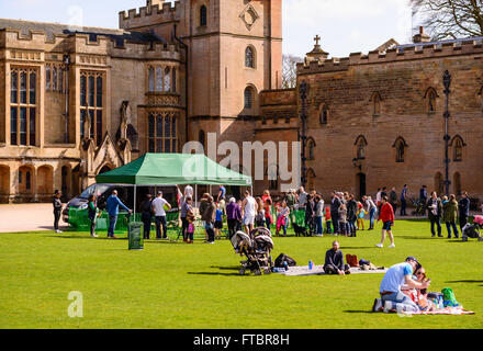 A family with young boy enjoy a picnic on lawn in front of Newstead Abbey. Stock Photo